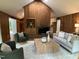 Inviting living room with wood paneled walls, vaulted ceiling, and ample seating at 102 Pebble Ct, Chapel Hill, NC 27516