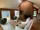Comfortable living room with a fireplace, wood paneled walls, and lots of natural light at 102 Pebble Ct, Chapel Hill, NC 27516