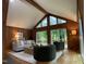 Light-filled living room with vaulted ceiling, wood paneled walls, and comfortable furnishings at 102 Pebble Ct, Chapel Hill, NC 27516