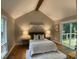 Comfortable primary bedroom with vaulted ceiling, deck access, and serene ambiance at 102 Pebble Ct, Chapel Hill, NC 27516