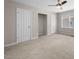 Spacious bedroom featuring neutral carpet, base molding, and multiple windows at 104 Archdale Dr, Durham, NC 27707