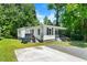 View of the home's exterior featuring the front porch, landscaping and driveway at 104 Archdale Dr, Durham, NC 27707