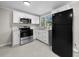 Modern kitchen with stainless steel appliances and white cabinets provides a clean, open feel at 104 Archdale Dr, Durham, NC 27707