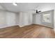 Spacious living room with hardwood floors, ceiling fan, and freshly painted walls at 104 Archdale Dr, Durham, NC 27707