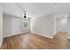 Bright and airy living room features hardwood floors, ceiling fan, and freshly painted walls at 104 Archdale Dr, Durham, NC 27707