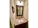 Cozy half bathroom featuring granite counter, stylish mirror, and well-maintained fixtures at 104 Fox Trail Ln, Morrisville, NC 27560