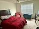 Bedroom featuring a ceiling fan, comfortable chair and a red comforter on the bed at 104 Fox Trail Ln, Morrisville, NC 27560