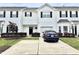 Charming townhome with white siding, black shutters, and a well-maintained front yard and driveway at 104 Fox Trail Ln, Morrisville, NC 27560