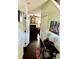 Bright hallway featuring hardwood floors, artwork, and access to various rooms in the house at 104 Fox Trail Ln, Morrisville, NC 27560