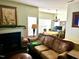 Inviting living room with fireplace, hardwood floors, and neutral tones, flowing into the dining area at 104 Fox Trail Ln, Morrisville, NC 27560