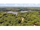 An aerial view looking over lush treetops, lake and open countryside at 106 Nations Cove, Louisburg, NC 27549