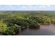 An aerial view looking over lush treetops, lake and open countryside at 106 Nations Cove, Louisburg, NC 27549