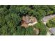 An aerial view of a home with brown roof surrounded by lush green trees at 106 Nations Cove, Louisburg, NC 27549