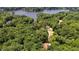 An aerial view looking over lush treetops and a lake with open countryside at 106 Nations Cove, Louisburg, NC 27549