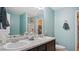 Bathroom featuring double sinks, tile backsplash, and a walk-in shower at 106 Nations Cove, Louisburg, NC 27549