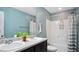 Bright bathroom with double sinks, a shower, and a toilet at 106 Nations Cove, Louisburg, NC 27549