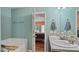 Bright bathroom featuring a double vanity, granite counters, and separate tub at 106 Nations Cove, Louisburg, NC 27549