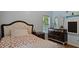 Comfortable bedroom showcasing a stylish bed and mirrored dresser at 106 Nations Cove, Louisburg, NC 27549