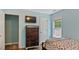 This bedroom features a wooden dresser with a TV on the wall and a window at 106 Nations Cove, Louisburg, NC 27549