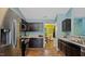 Modern kitchen with stainless steel appliances, dark cabinets, and granite countertops at 106 Nations Cove, Louisburg, NC 27549