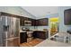 Modern kitchen with stainless steel appliances, dark cabinets, and granite countertops at 106 Nations Cove, Louisburg, NC 27549
