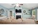 Inviting living room features cozy seating, fireplace, and a modern ceiling fan for comfort at 106 Nations Cove, Louisburg, NC 27549