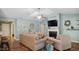 Open-concept living room with fireplace, television, and cozy seating arrangements at 106 Nations Cove, Louisburg, NC 27549