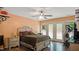 Warm bedroom with hardwood floors, a queen bed, and natural light from the windows at 106 Nations Cove, Louisburg, NC 27549