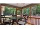 Relaxing screened-in porch with comfortable seating, perfect for enjoying the outdoors at 106 Nations Cove, Louisburg, NC 27549
