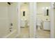 View of adjoining bathrooms, each featuring a shower-tub and a toilet with sink at 107 Ashley Forest Rd # B, Chapel Hill, NC 27514