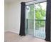 Bedroom featuring black-out curtains and sliding glass doors to outdoor deck at 107 Ashley Forest Rd # B, Chapel Hill, NC 27514