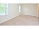 Bedroom featuring neutral carpet, paint and bright natural light from two windows at 107 Ashley Forest Rd # B, Chapel Hill, NC 27514