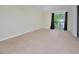 Spacious, carpeted bedroom with sliding glass door leading to a balcony at 107 Ashley Forest Rd # B, Chapel Hill, NC 27514