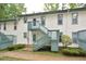 Apartment building featuring painted siding, green trim, and stairs to the second level at 107 Ashley Forest Rd # B, Chapel Hill, NC 27514