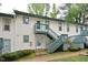 Apartment building featuring painted siding, green trim, and stairs to the second level at 107 Ashley Forest Rd # B, Chapel Hill, NC 27514