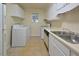 Functional kitchen with essential appliances, white cabinets, and tile flooring at 107 Ashley Forest Rd # B, Chapel Hill, NC 27514