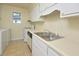 Traditional kitchen featuring white cabinets, laminate countertops, and double basin sink at 107 Ashley Forest Rd # B, Chapel Hill, NC 27514