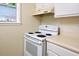 Standard white electric range and above range vent complete this traditional kitchen at 107 Ashley Forest Rd # B, Chapel Hill, NC 27514