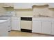Functional kitchen layout with white cabinets, dishwasher, and stainless steel sink at 107 Ashley Forest Rd # B, Chapel Hill, NC 27514
