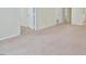 Neutral carpeted living room with access to multiple doorways and ample space at 107 Ashley Forest Rd # B, Chapel Hill, NC 27514