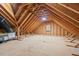 Unfinished attic with exposed wooden rafters, plywood flooring, a vent, and possible hvac components at 107 Regiment Way, Durham, NC 27705