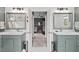 Well-lit bathroom with dual sinks, quartz counters, and marble tile floors at 107 Regiment Way, Durham, NC 27705