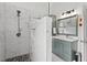 Modern bathroom features a walk-in shower with marble-style tile and dark pebble flooring, plus a beautiful sage vanity at 107 Regiment Way, Durham, NC 27705