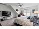 Bedroom features a large bed, ceiling fan, TV, and a cozy sitting area at 107 Regiment Way, Durham, NC 27705