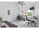 Well-lit bedroom with an office setup, ceiling fan, and neutral colors at 107 Regiment Way, Durham, NC 27705