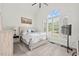 Bright bedroom with large window, arched transom, shutters, and neutral decor at 107 Regiment Way, Durham, NC 27705