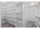 Spacious walk-in closet with ample shelving, carpeted floors, and white trim at 107 Regiment Way, Durham, NC 27705