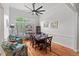 Elegant dining room with a large window, hardwood floors, and modern furnishings at 107 Regiment Way, Durham, NC 27705