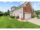 Well maintained home featuring brick and vinyl siding, a two-car garage, and manicured lawn at 107 Regiment Way, Durham, NC 27705