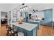 Spacious kitchen with island, stainless steel appliances, and blue and white custom cabinets at 107 Regiment Way, Durham, NC 27705